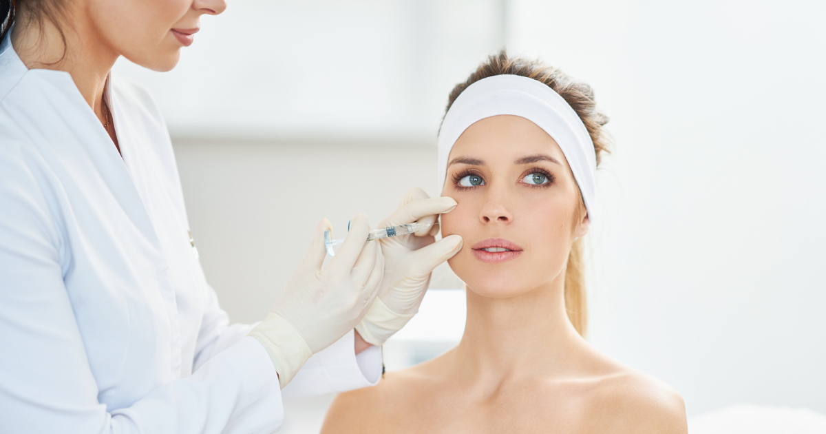 Woman receiving dermal fillers injection in her cheek at a clinic in Yardley, PA